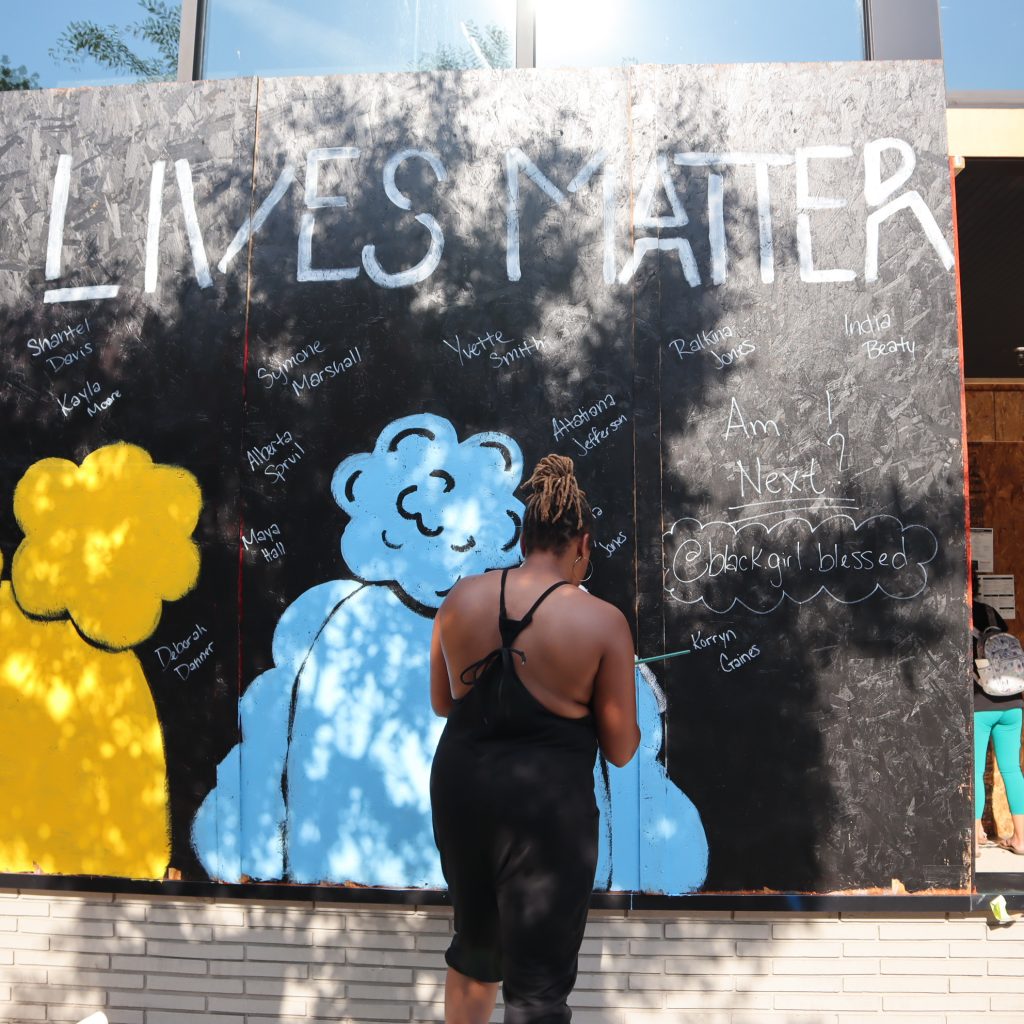 artist painting black lives matter mural