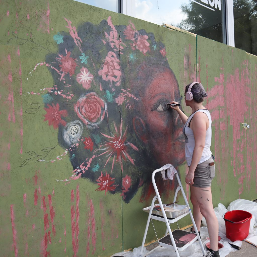 artist painting a mural in greensboro nc