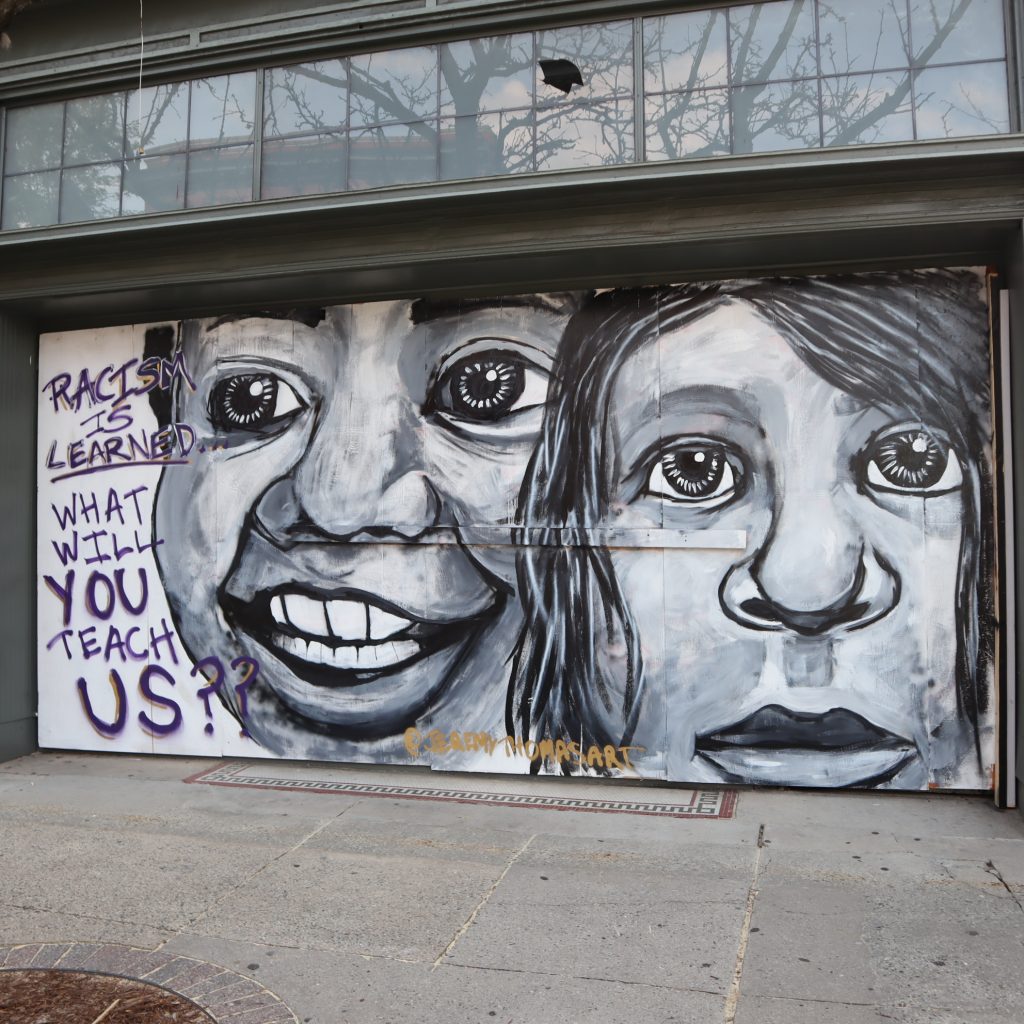 Mural in downtown Greensboro reads: Racism is Learned. What will you teach us?