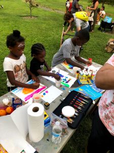 Children painting in a park.