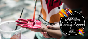 Close up shot of a small child painting the palms of their hands red. An icon is placed in the corner that reads "when you support the arts, creativity happens"