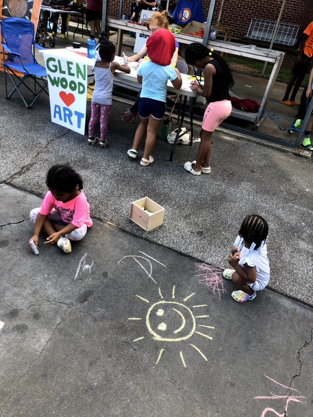 Children play and draw with chalk.